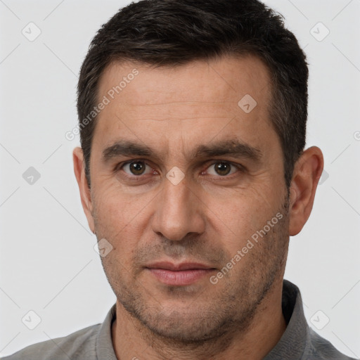 Joyful white adult male with short  brown hair and brown eyes