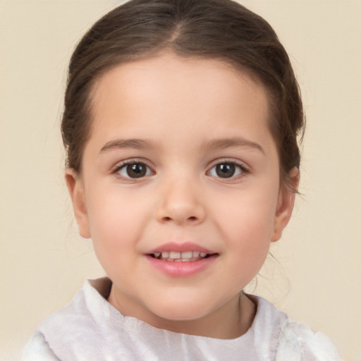 Joyful white child female with short  brown hair and brown eyes