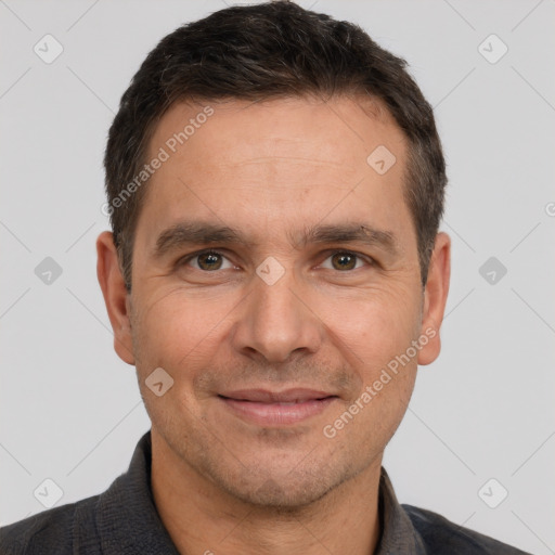 Joyful white adult male with short  brown hair and brown eyes