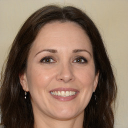 Joyful white adult female with medium  brown hair and brown eyes