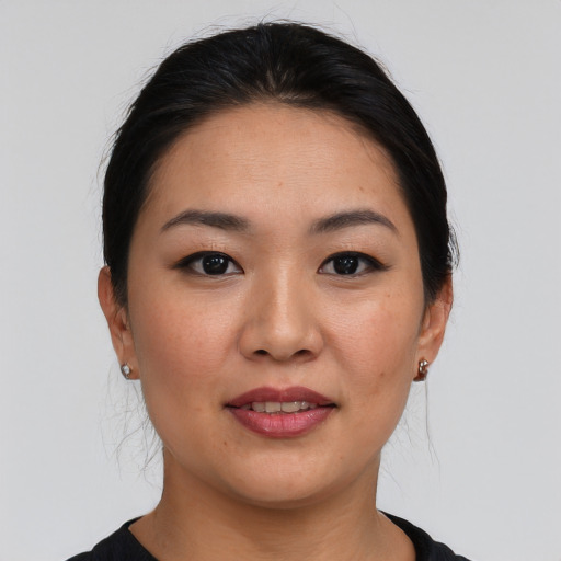 Joyful asian young-adult female with medium  black hair and brown eyes