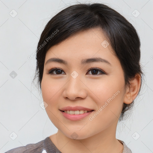 Joyful asian young-adult female with medium  brown hair and brown eyes