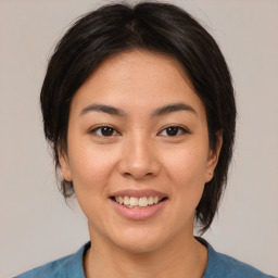 Joyful asian young-adult female with medium  brown hair and brown eyes