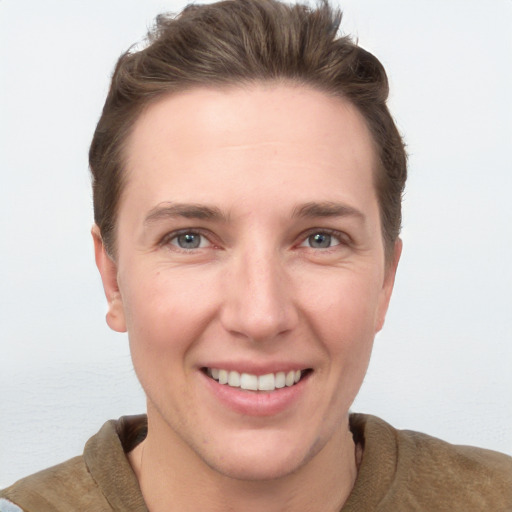 Joyful white young-adult female with short  brown hair and grey eyes