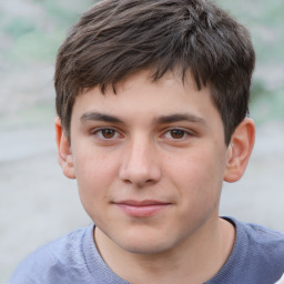 Joyful white child male with short  brown hair and brown eyes