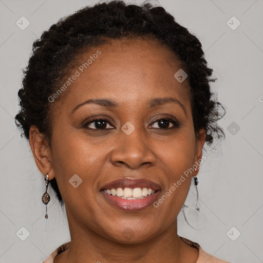 Joyful black young-adult female with long  brown hair and brown eyes