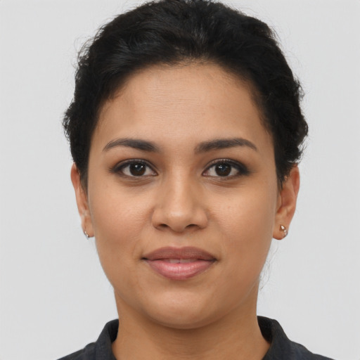 Joyful latino young-adult female with short  brown hair and brown eyes