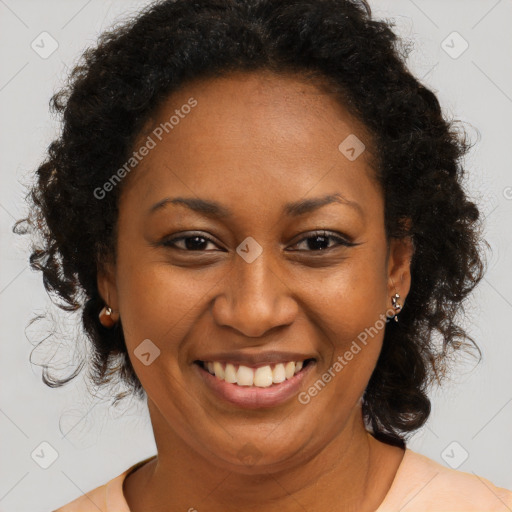 Joyful black adult female with long  brown hair and brown eyes