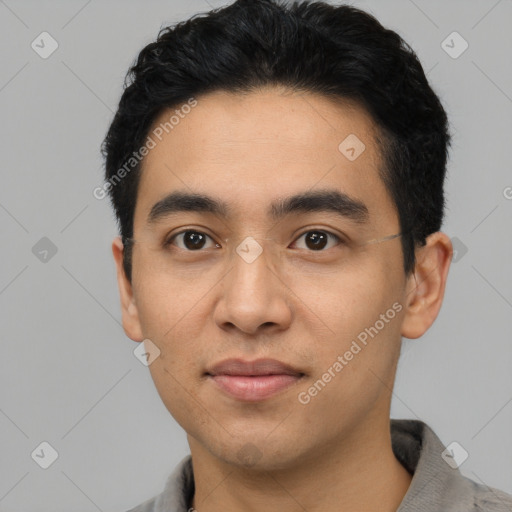 Joyful latino young-adult male with short  black hair and brown eyes