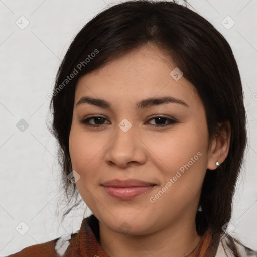 Joyful latino young-adult female with medium  brown hair and brown eyes