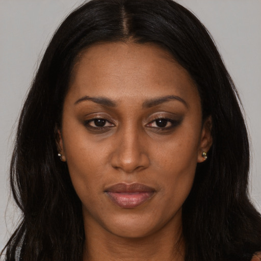 Joyful latino adult female with long  brown hair and brown eyes