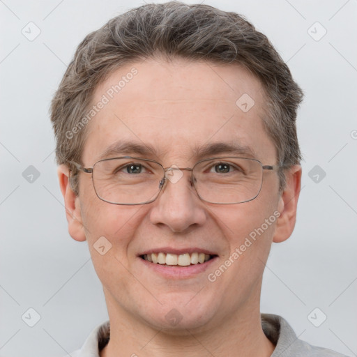 Joyful white adult male with short  brown hair and grey eyes