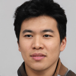 Joyful asian young-adult male with short  black hair and brown eyes