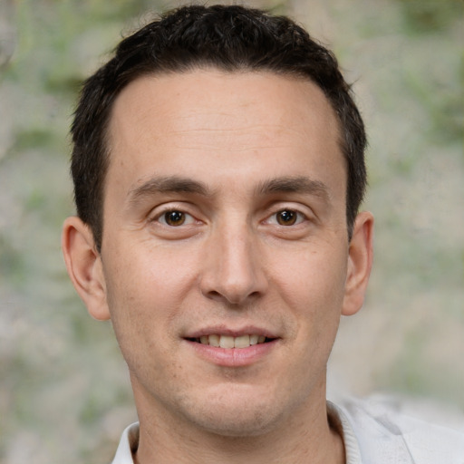 Joyful white adult male with short  brown hair and brown eyes