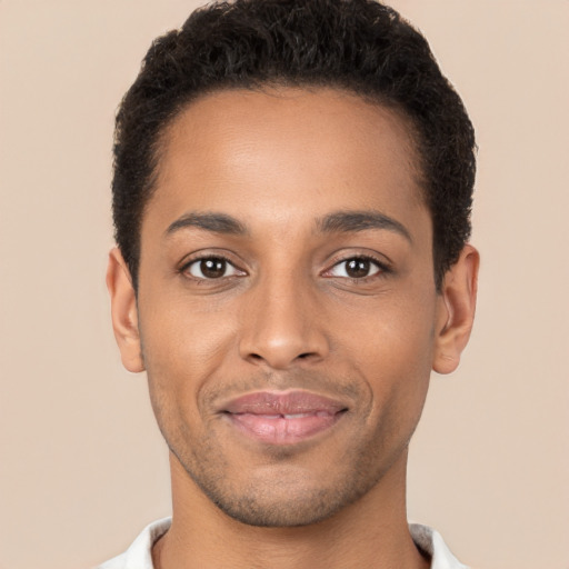 Joyful black young-adult male with short  brown hair and brown eyes