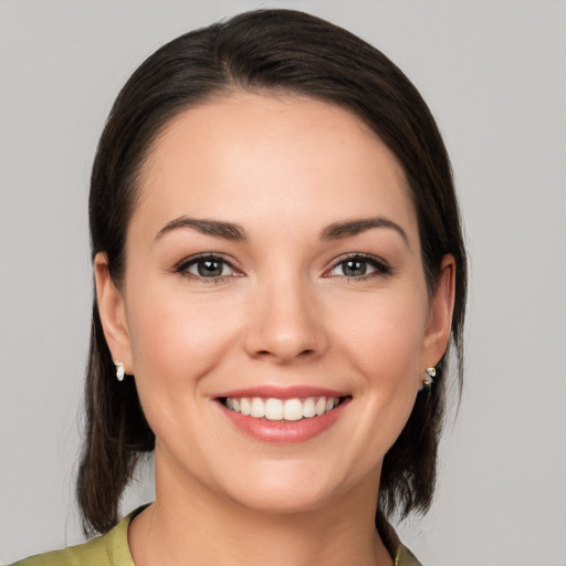 Joyful white young-adult female with medium  brown hair and brown eyes