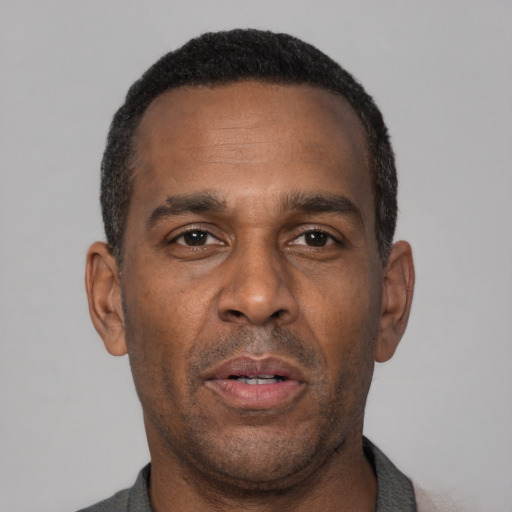 Neutral latino adult male with short  black hair and brown eyes