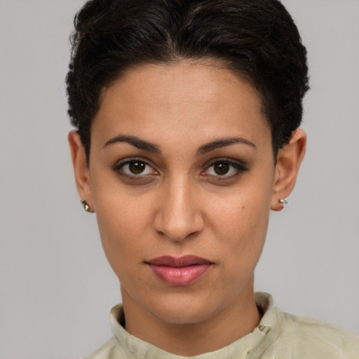 Joyful latino young-adult female with short  brown hair and brown eyes