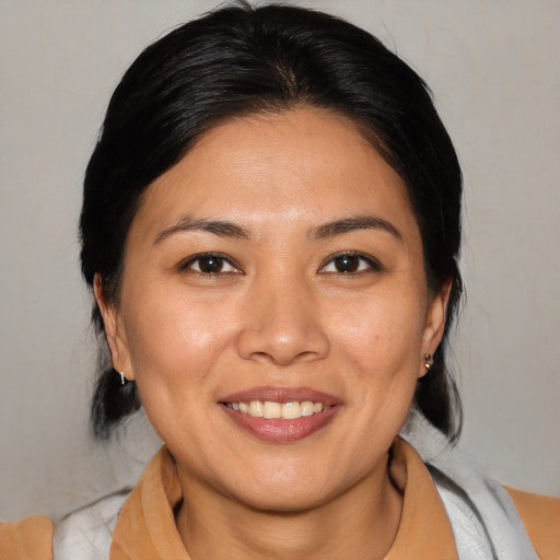 Joyful asian young-adult female with medium  brown hair and brown eyes