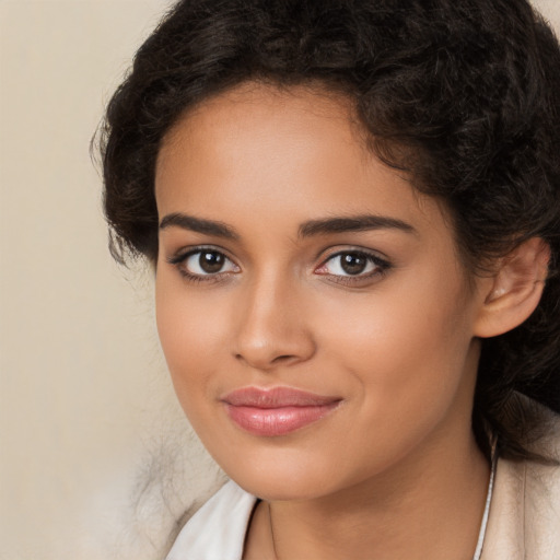 Joyful latino young-adult female with long  brown hair and brown eyes