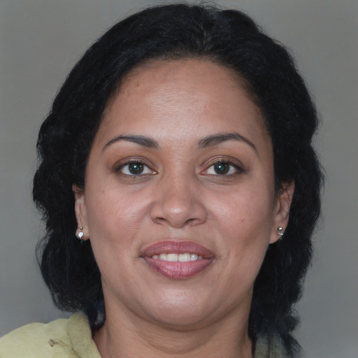 Joyful black adult female with medium  brown hair and brown eyes