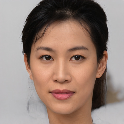 Joyful asian young-adult female with medium  brown hair and brown eyes