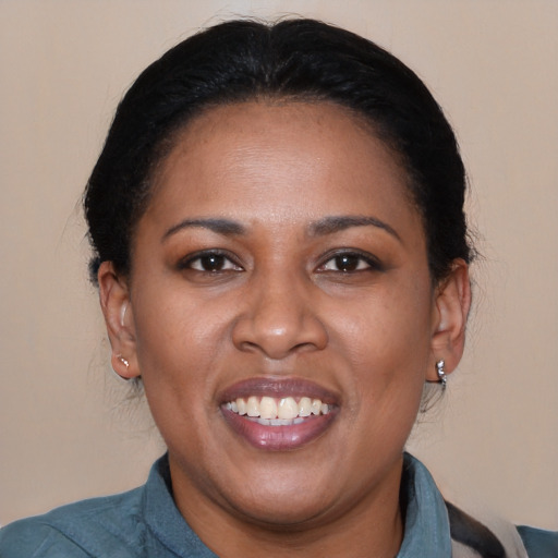 Joyful black adult female with medium  brown hair and brown eyes