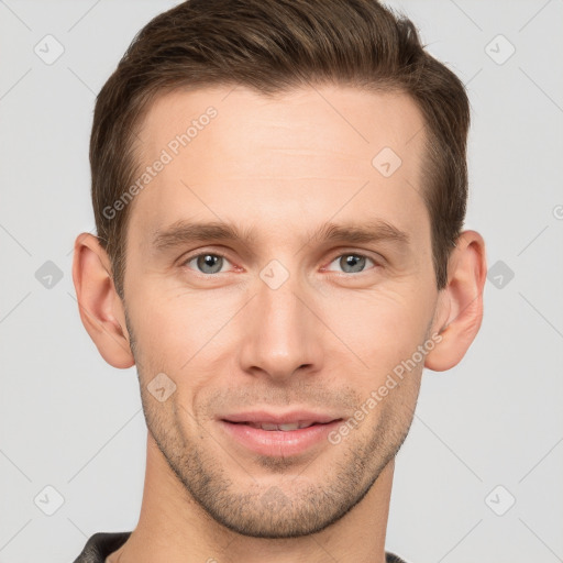 Joyful white young-adult male with short  brown hair and grey eyes