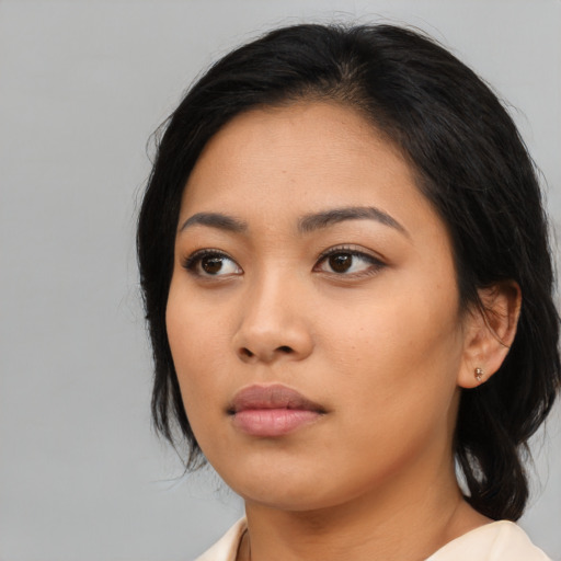Neutral asian young-adult female with medium  black hair and brown eyes