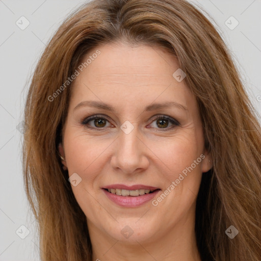 Joyful white adult female with long  brown hair and brown eyes