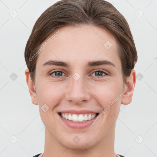 Joyful white young-adult female with short  brown hair and grey eyes