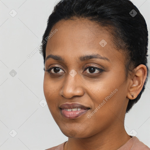 Joyful black young-adult female with short  black hair and brown eyes