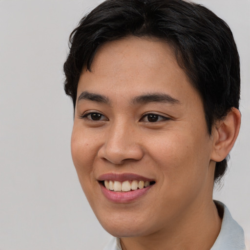 Joyful asian young-adult female with short  brown hair and brown eyes