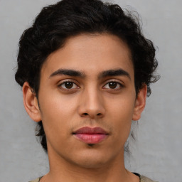 Joyful latino young-adult male with short  brown hair and brown eyes