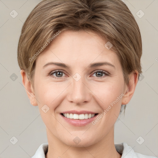 Joyful white young-adult female with short  brown hair and grey eyes