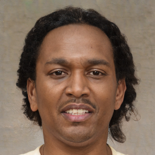 Joyful latino adult male with short  brown hair and brown eyes