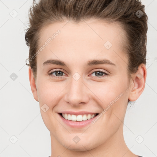 Joyful white young-adult female with short  brown hair and grey eyes