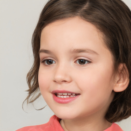 Joyful white child female with medium  brown hair and brown eyes