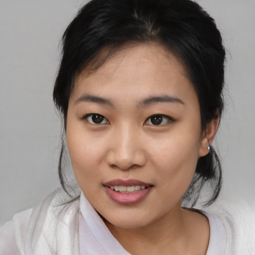 Joyful asian young-adult female with medium  brown hair and brown eyes