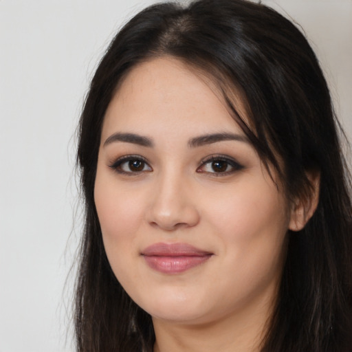 Joyful white young-adult female with long  black hair and brown eyes