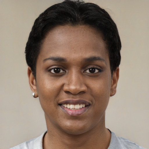 Joyful black young-adult female with short  black hair and brown eyes
