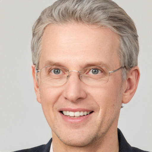 Joyful white middle-aged male with short  brown hair and grey eyes