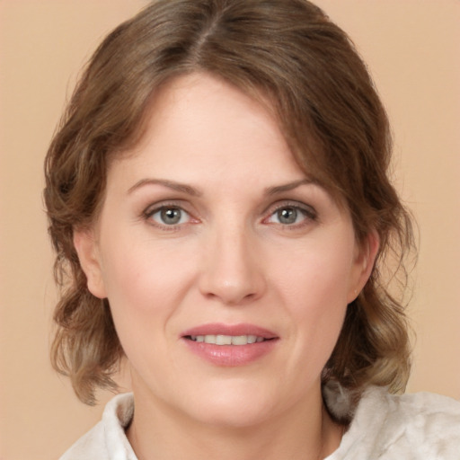 Joyful white young-adult female with medium  brown hair and green eyes