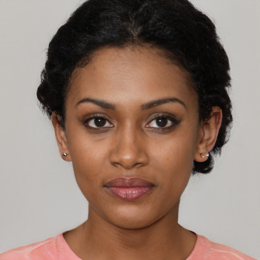 Joyful black young-adult female with short  black hair and brown eyes