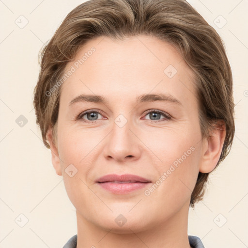 Joyful white young-adult female with short  brown hair and grey eyes