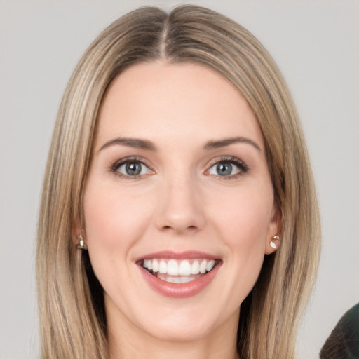 Joyful white young-adult female with long  brown hair and brown eyes