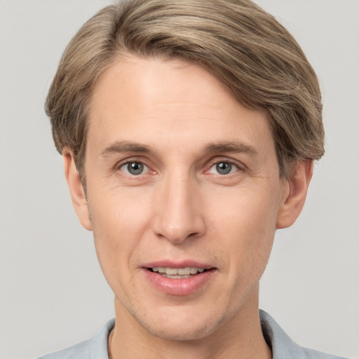 Joyful white adult male with short  brown hair and brown eyes