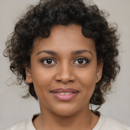 Joyful black young-adult female with medium  brown hair and brown eyes