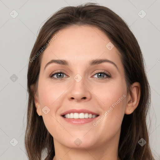 Joyful white young-adult female with long  brown hair and grey eyes