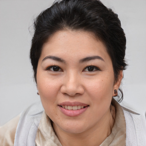 Joyful asian young-adult female with medium  brown hair and brown eyes